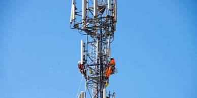RF engineer conducting emissions testing on a rooftop cell tower site.
