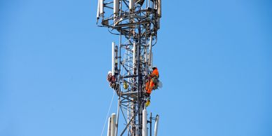RF engineer conducting emissions testing on a rooftop cell tower site