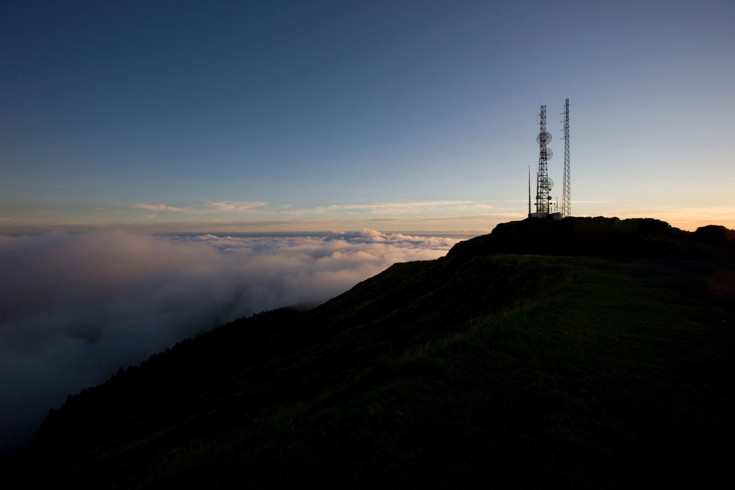 Mountain skyline with a cell tower providing wireless coverage 