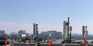 Cell tower antennas on a commercial rooftop with RF safety barriers – SCM Advisors compliance audit