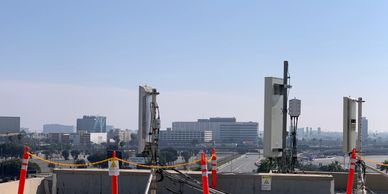 Cell tower antennas on a commercial rooftop with RF safety barriers – SCM Advisors compliance audit