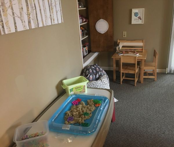 Children's play area with sand and toys.