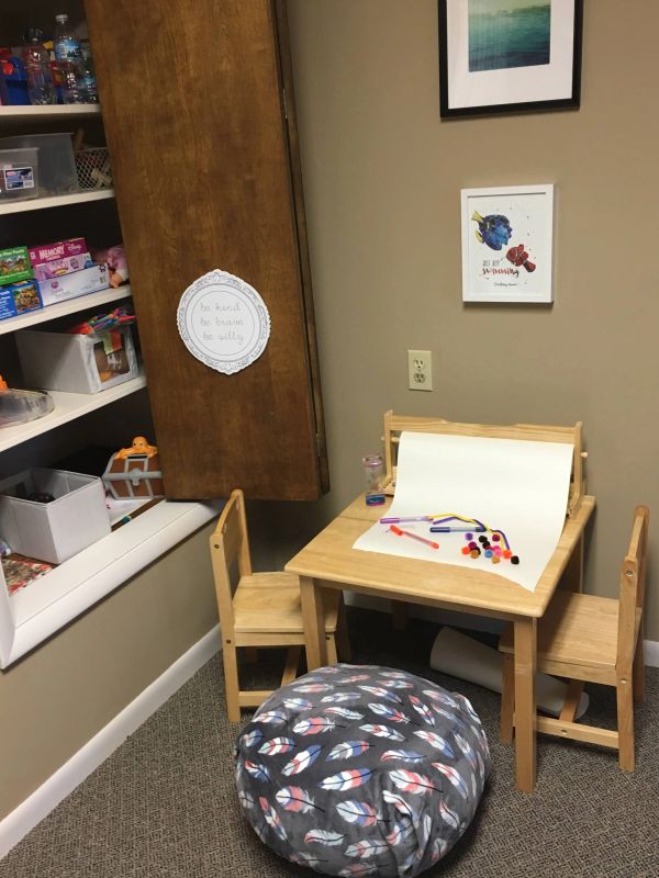 Cozy kids' art and play corner with table, chairs, and craft supplies.