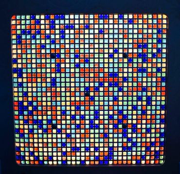 Colorful mosaic of small squares with varied colors.