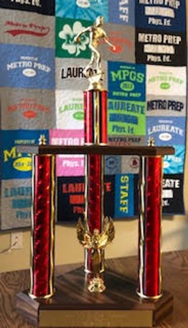 A large sports trophy with a gold athlete figure on top.