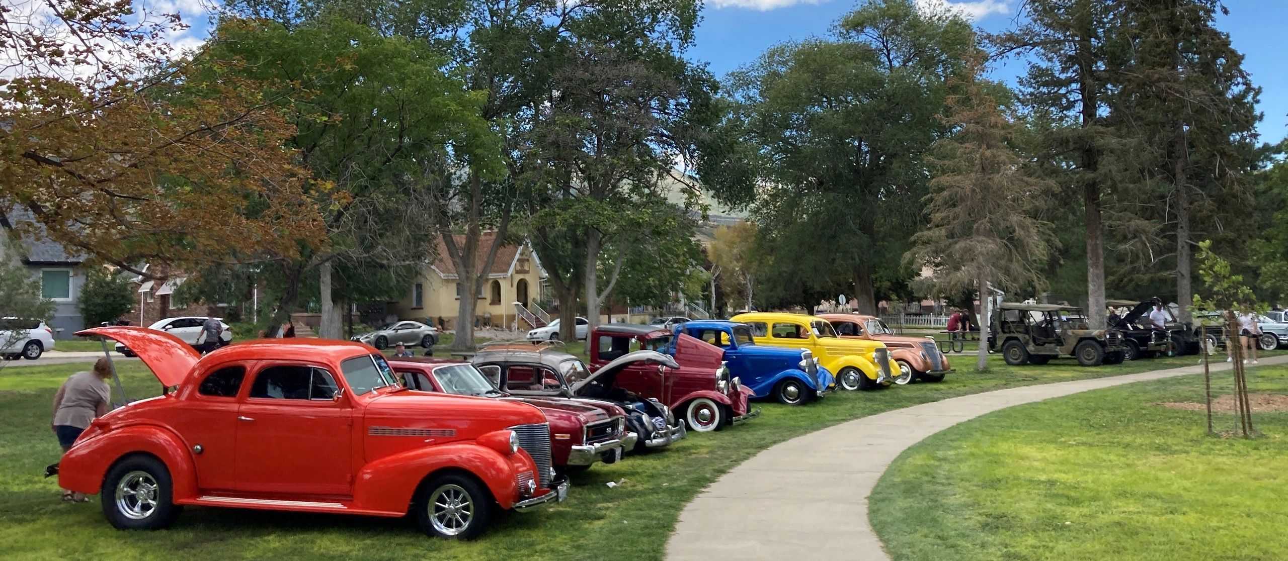 A row of brightly painted collectible cars at the Copperton Town Days car show.