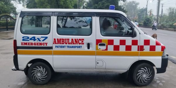 White ambulance van with red emergency markings.
