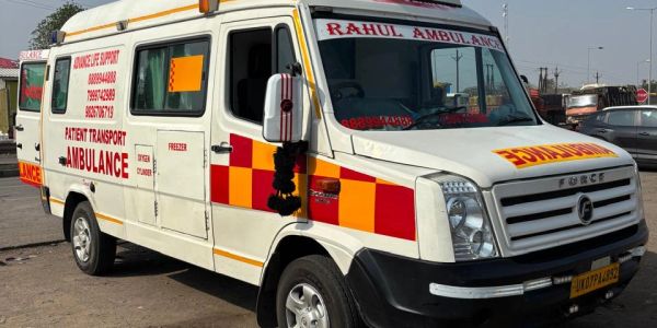 White patient transport ambulance with red markings.