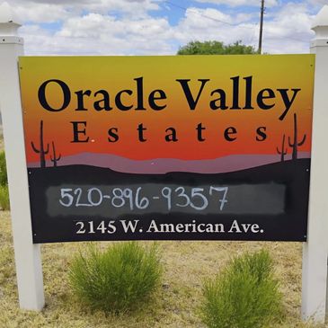 Sign for Oracle Valley Estates with contact info and address.