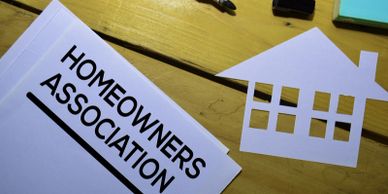 paper house with homeowners association documents