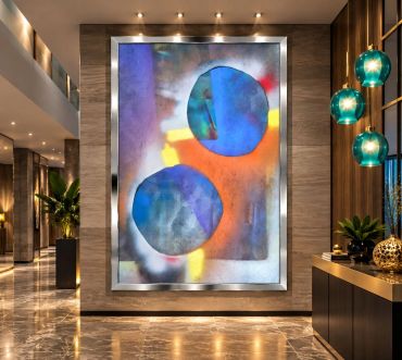 Abstract art with blue circles in a modern hallway.
