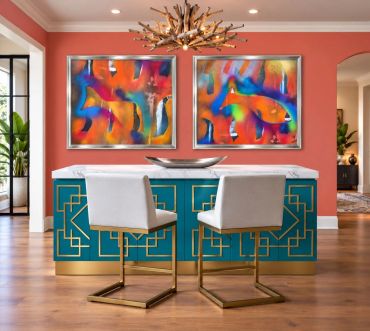 Modern dining area with colorful abstract art and gold-accented furniture.