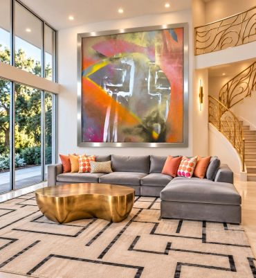 Modern living room with large abstract painting and unique coffee table.