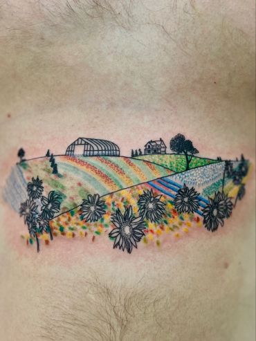 Colorful farm landscape tattoo with sunflowers and farmhouse.