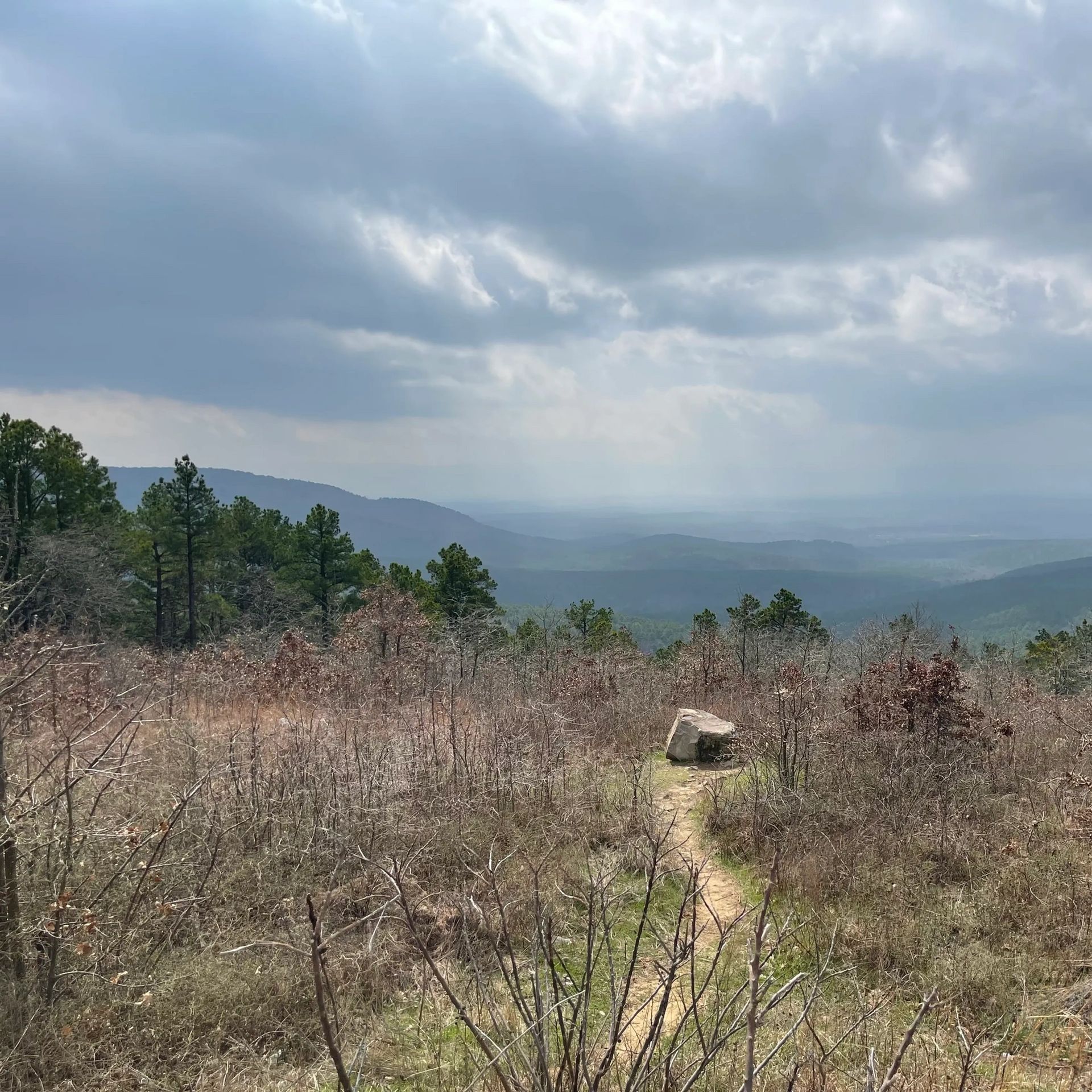 Scenic mountainous landscape under cloudy sky.