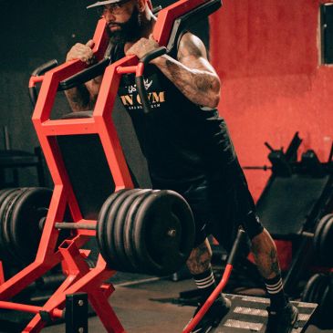 Man doing heavy weight calf raise exercise.