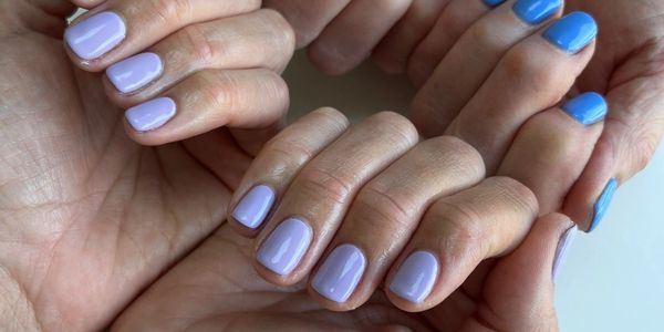 two pairs of hands with blue manicured nails