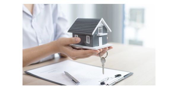 two hands delivering a house and a set of keys