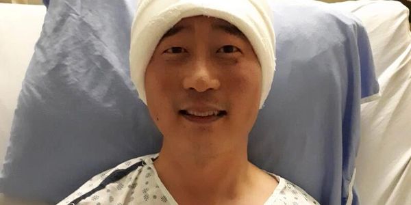 Alex Choi in the hospital after his brain surgery
