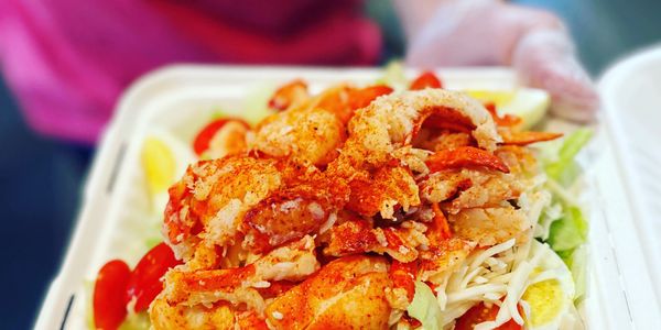 Spicy seasoned lobster on salad.