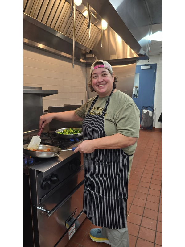 Chef Di cooking at stovetop