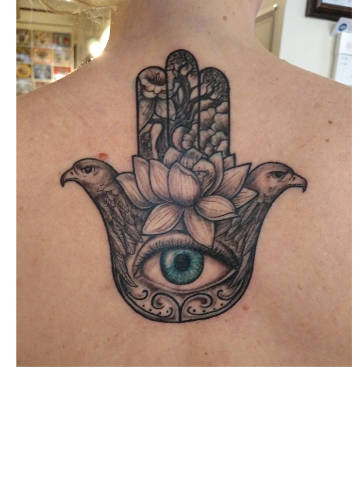 hamsa tattoo on woman's upper back done by kerrytat2  Kerry O'Neill 