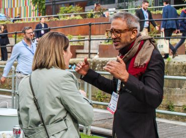 Two people engaged in animated conversation outdoors.