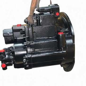 Black industrial hydraulic pump with red caps and a lifting strap.