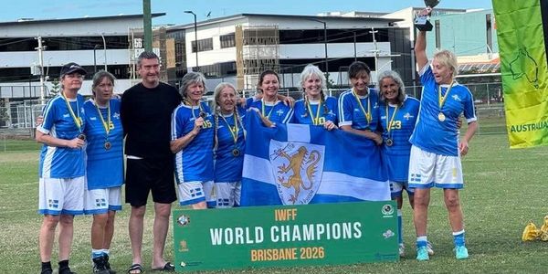 A victorious women's team celebrates winning the IWFF World Championship 2026 in Brisbane.