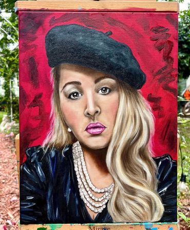 Portrait of a woman in a black beret and pearl necklace against a red background.