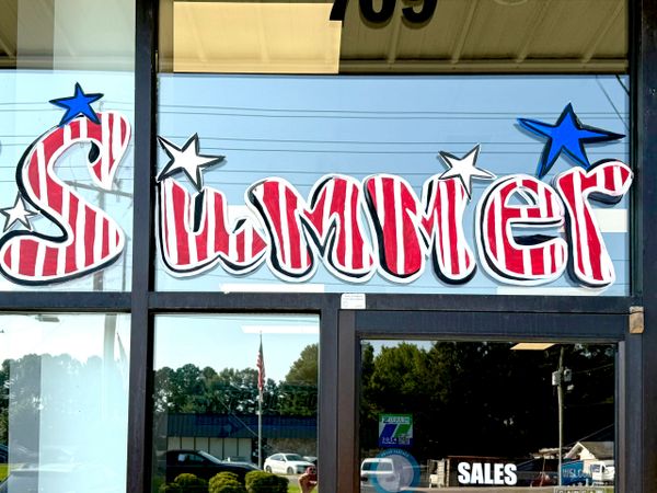 Window painting reads 'Summer' with patriotic red, white, and blue colors and stars.