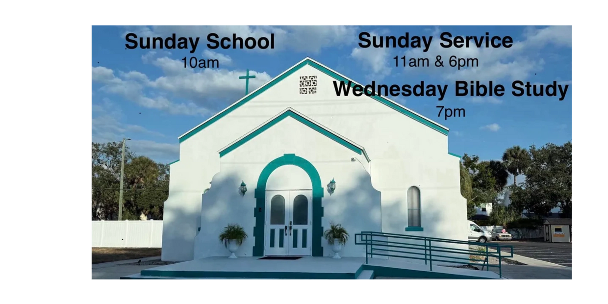 White church building with teal trim and service times displayed.