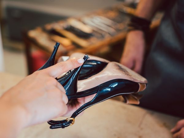 A professional repairing a pair of shoes