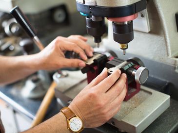 A person using a key cutting machine