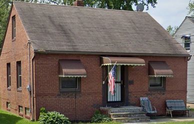 Small brick house with an American flag.