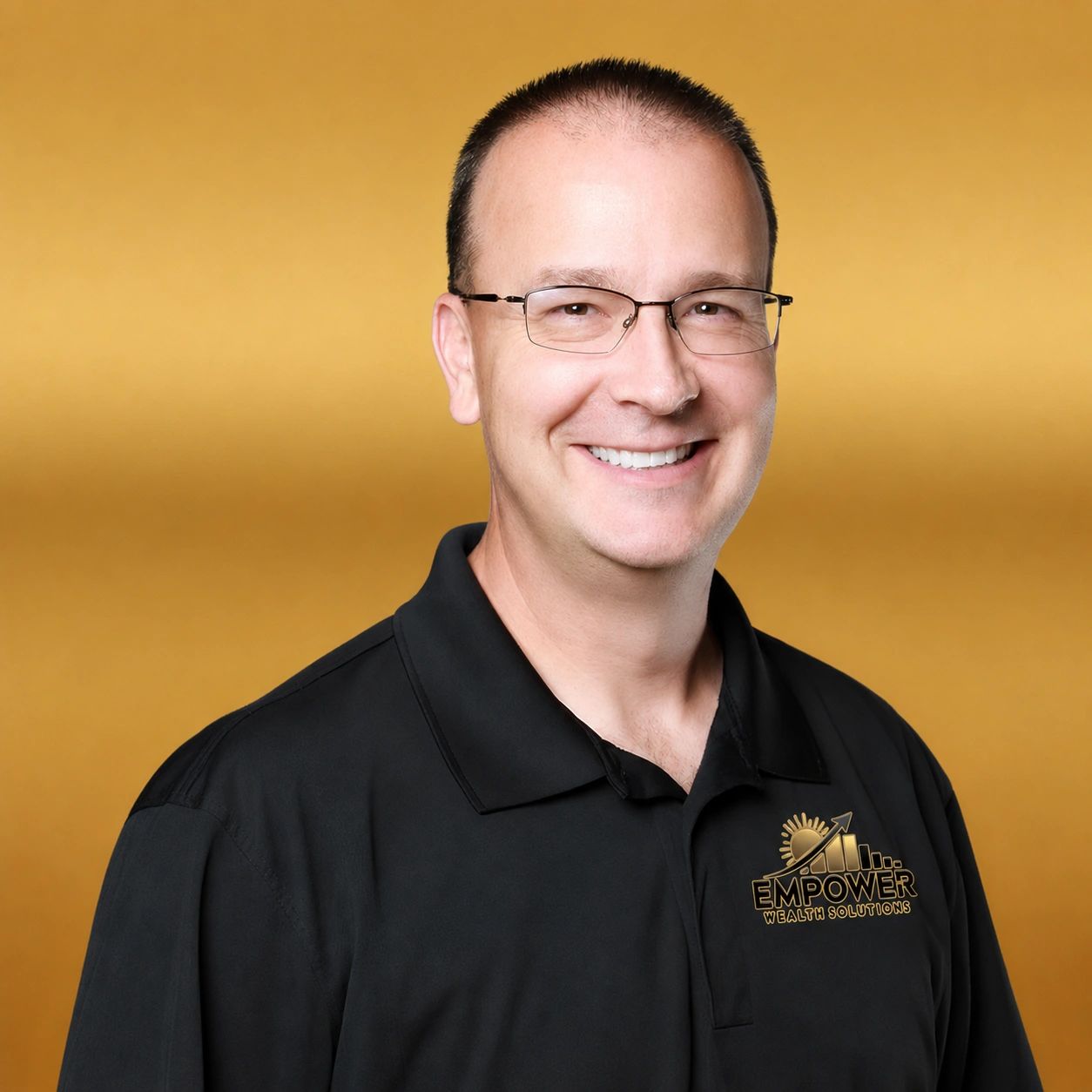 Smiling man wearing glasses and a black polo with Empower Wealth Solutions logo.