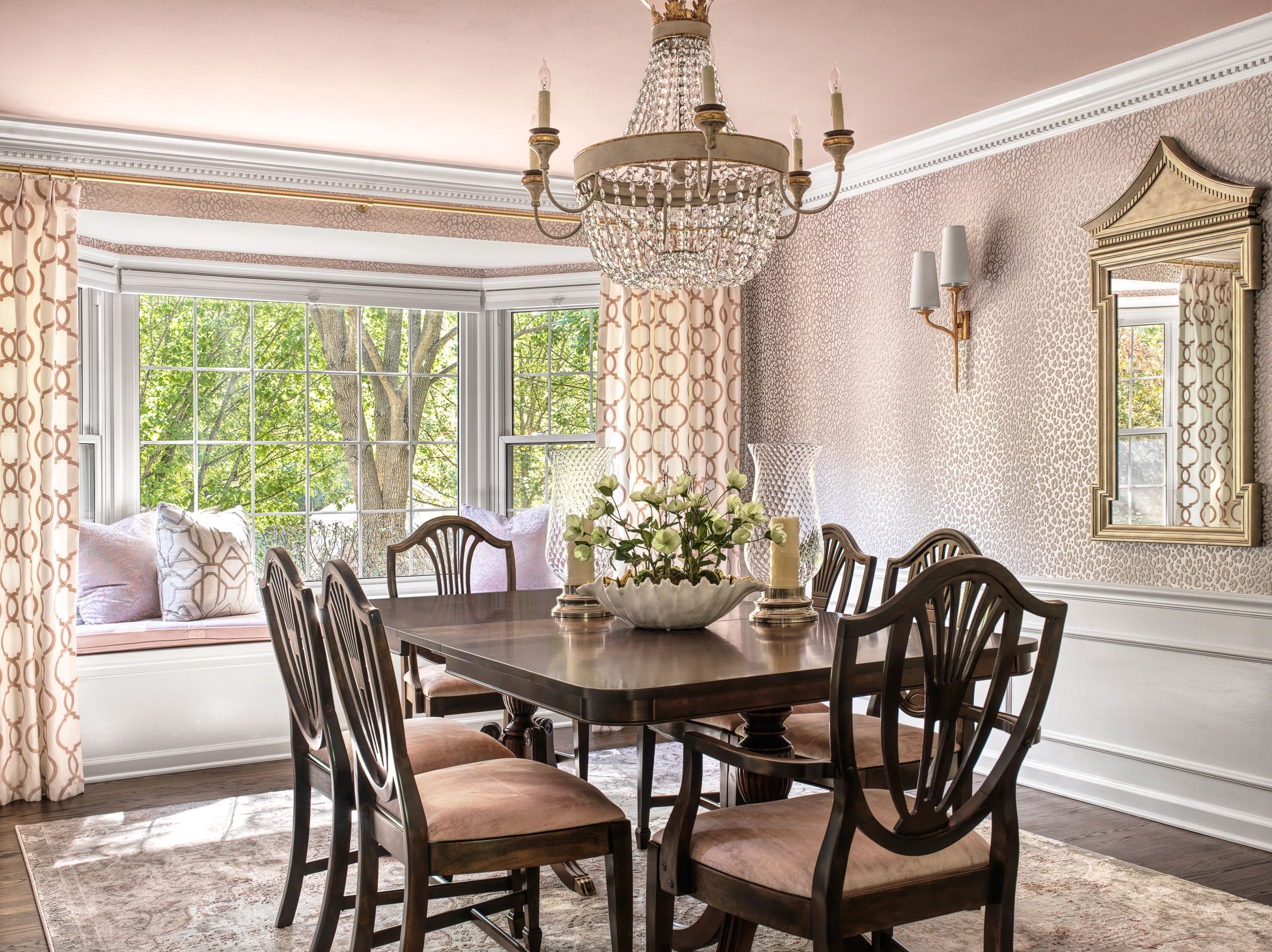 Elegant, blush colored dining room with French inspired chandelier.