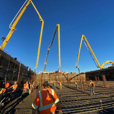 Silverline Construction workers with multiple concrete pumps. 