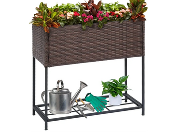 Brown wicker planter box with metal bottom shelf for garden tools