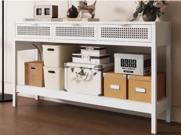 White wood console with 3 drawers and rattan fascia stacked with storage boxes and deco  figurines 