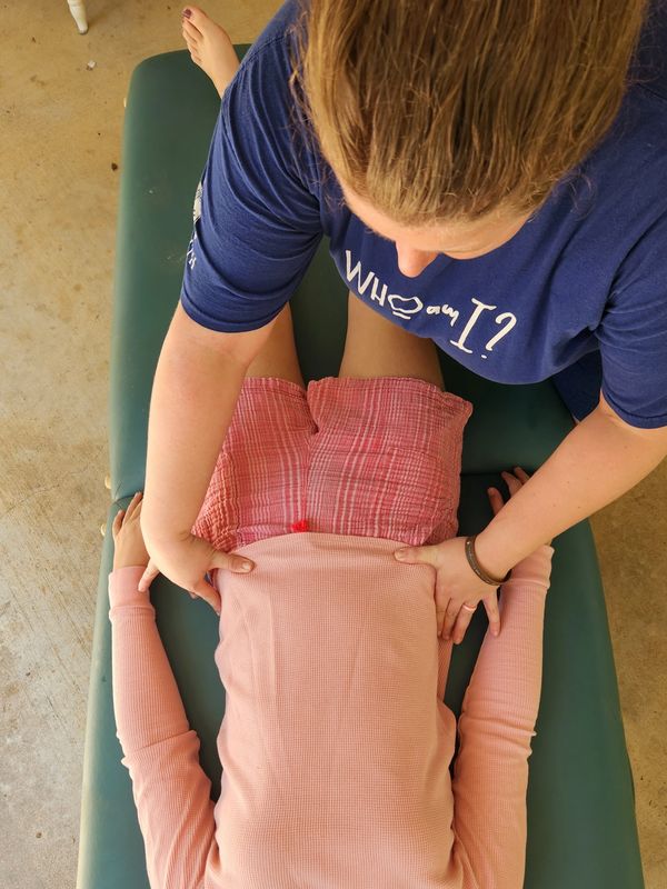 Anna treating her teenage daughter for scoliosis that set her free from constant bowel disturbances 