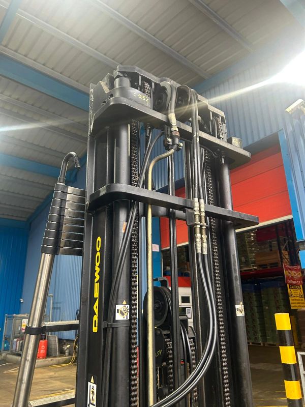 Close-up of a Daewoo forklift mast inside a warehouse.