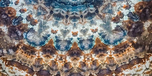 A vibrant abstract pattern with blue, brown, and orange hues.