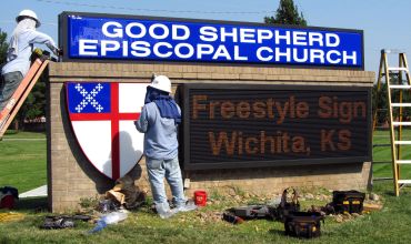 Workers install a sign at Good Shepherd Episcopal Church in Wichita.