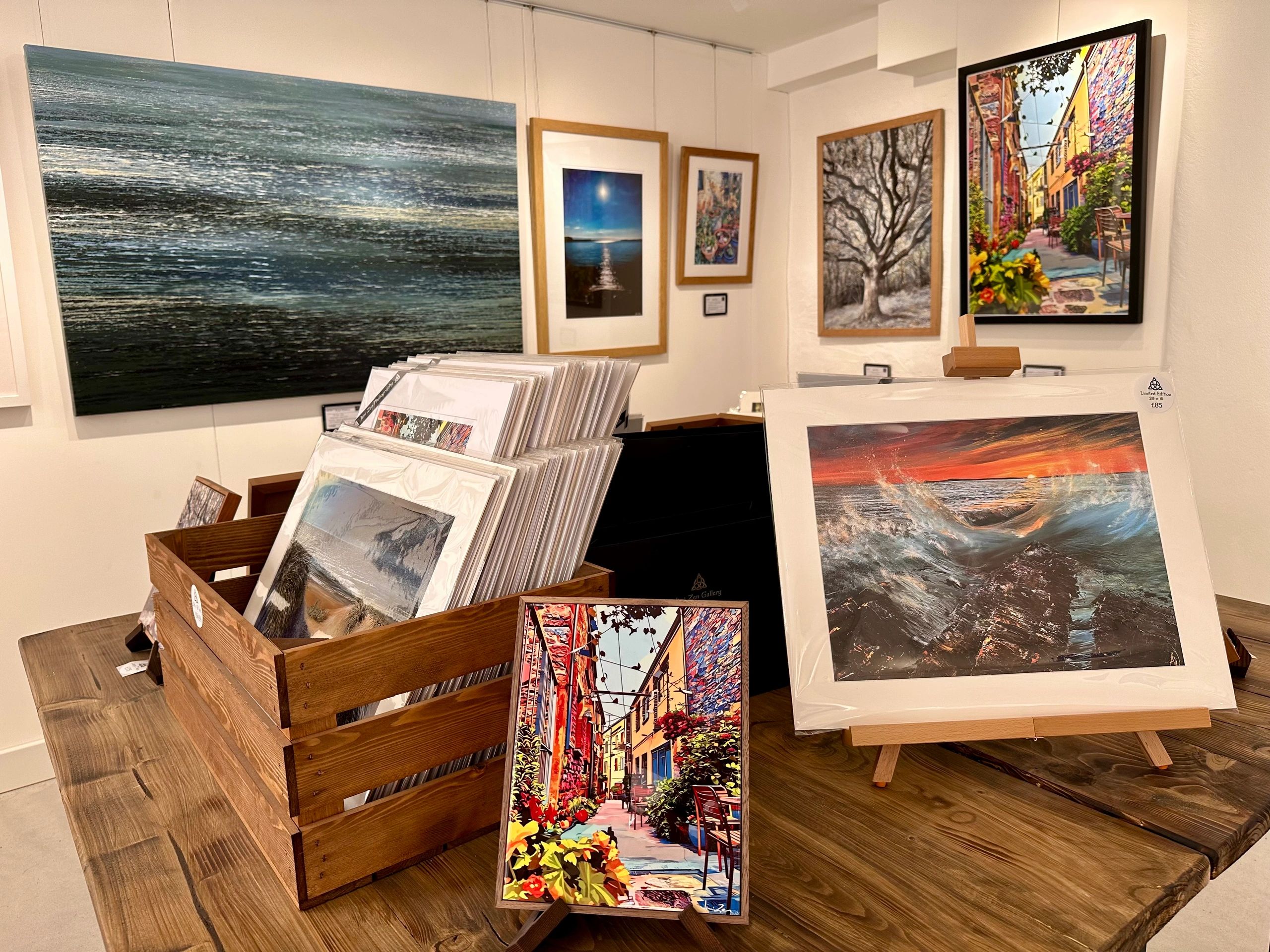 photograph of a corner in a galley with multiple pictures on display.