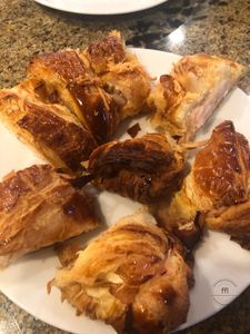 Plate of various pastries with golden crusts.