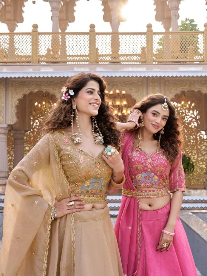 Two women in traditional Indian attire smiling.