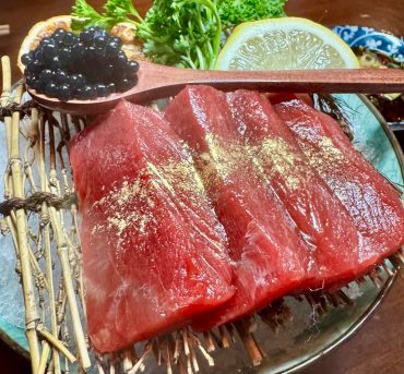 Fresh sashimi with black tapioca pearls and lemon slice.