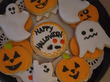 Halloween-themed decorated cookies including pumpkins and ghosts.