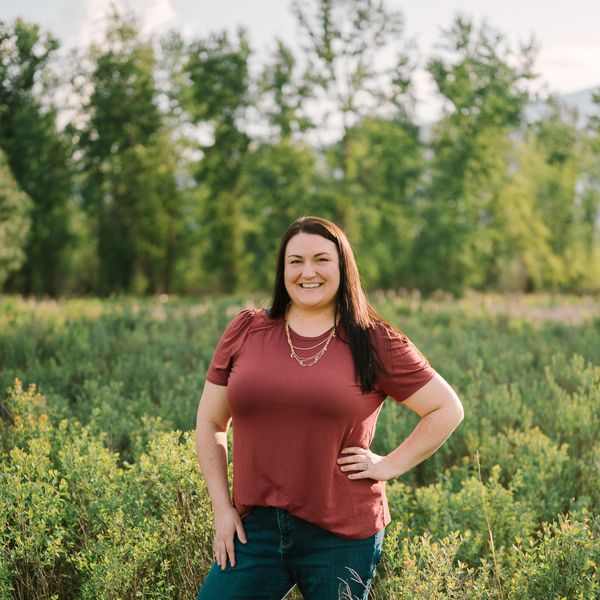 Woman smiling outdoors in nature.